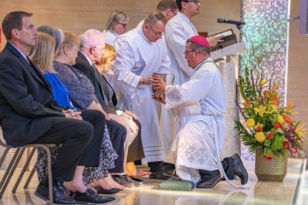 Bishop Bonnar grips a jug of water to wash feet during Holy Thursday 2024. Photo by Brian Keith.