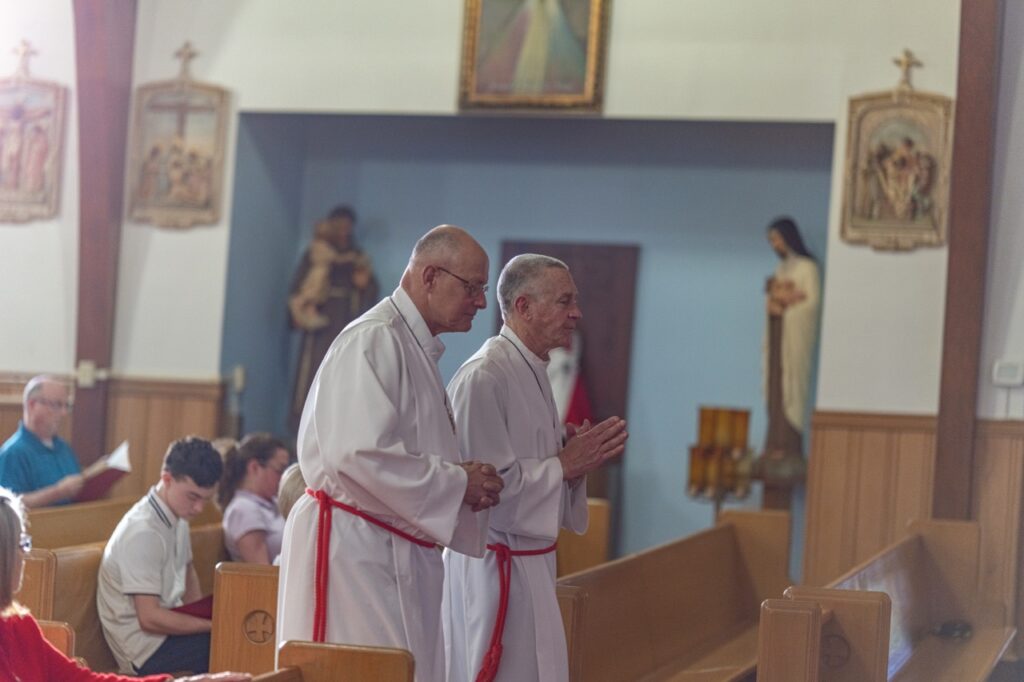 Two deacons walk in procession at Good Friday Liturgy 2024 at St. Mary and St. Joseph Parish in Newton Falls. Photo by Brian Keith.