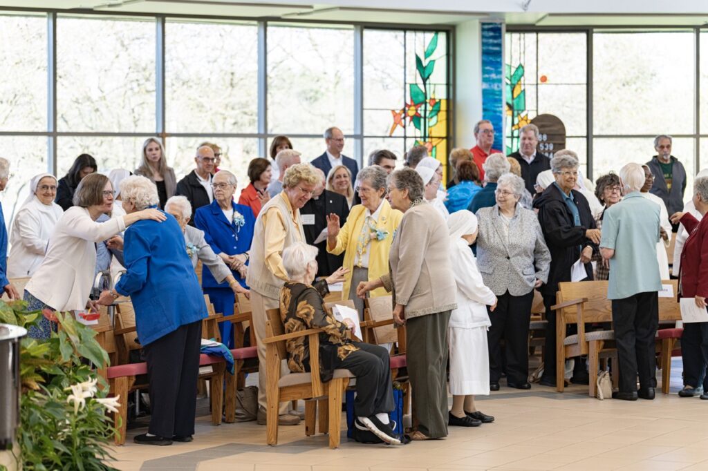 Religious sisters gather and greet each other during the Mass. Photo by Brian Keith. 