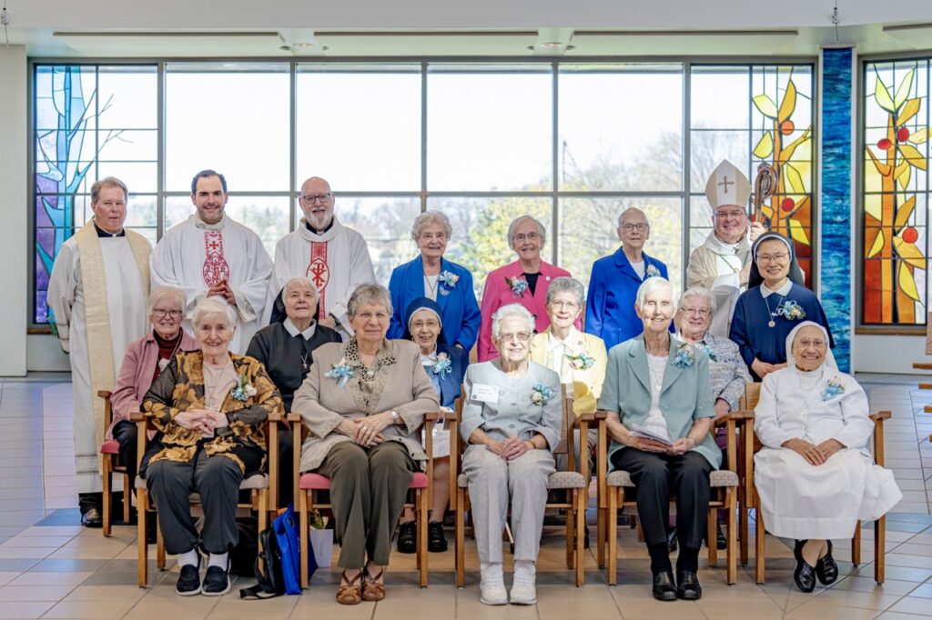 Two rows of religious sisters pose at the Mass honoring Jubilarians. Photo by Brian Keith.