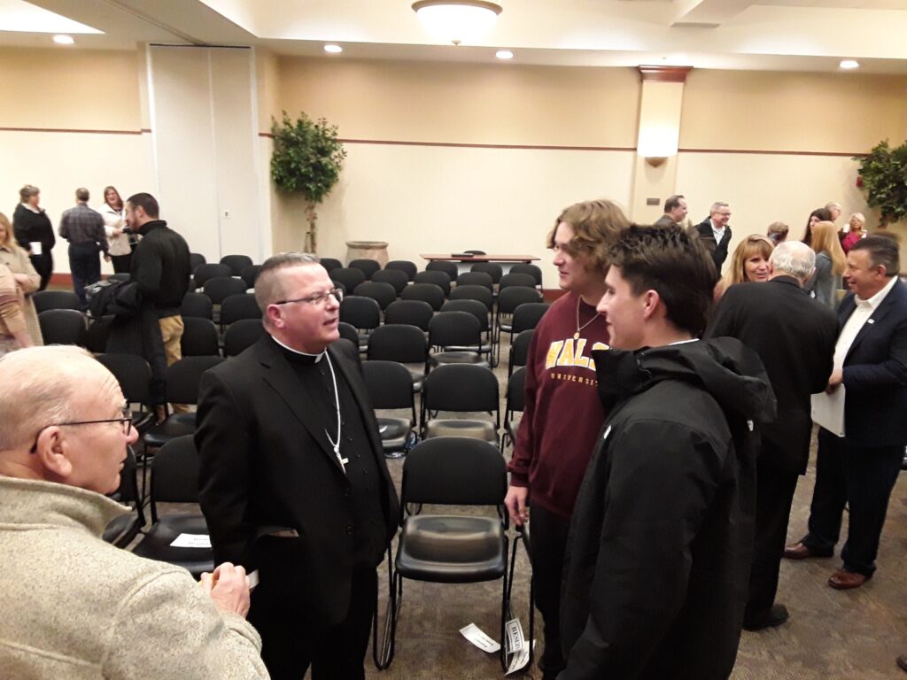 Bishop Bonnar greets those in attendance after the program