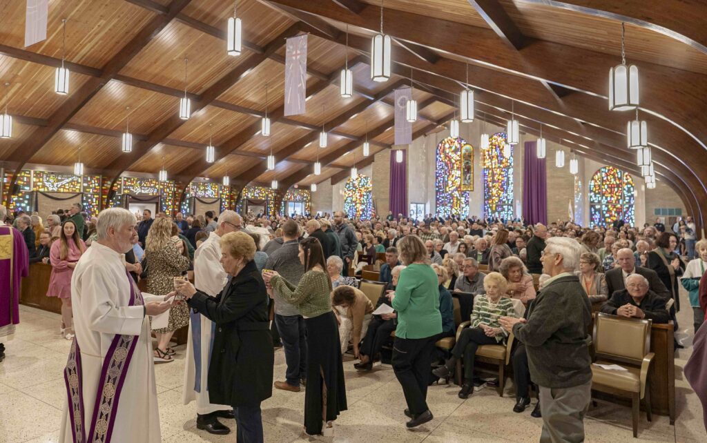 Parishioners line up for communion at St. Patrick Parish's reopening. Photo by Brian Keith