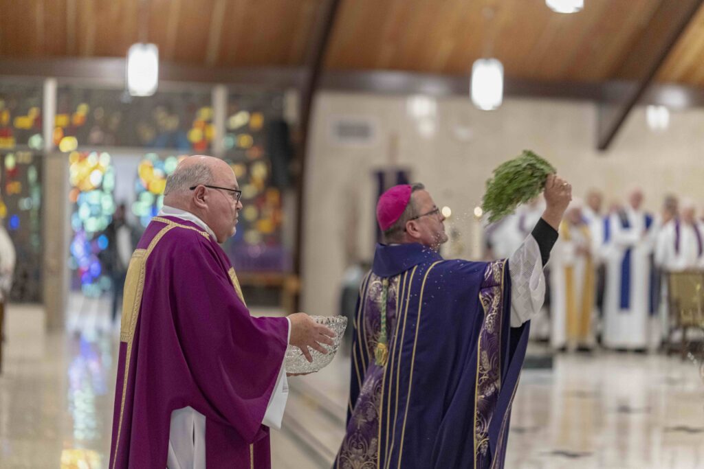 Bishop Bonnar blesses the sanctuary with holy water at St. Patrick Parish in Hubbard. Photo by Brian Keith