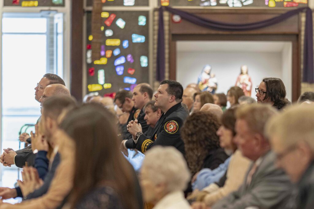 First Responders pray in the first two pews at the rededication Mass at St. Patrick Parish in Hubbard. Photo by Brian Keith.