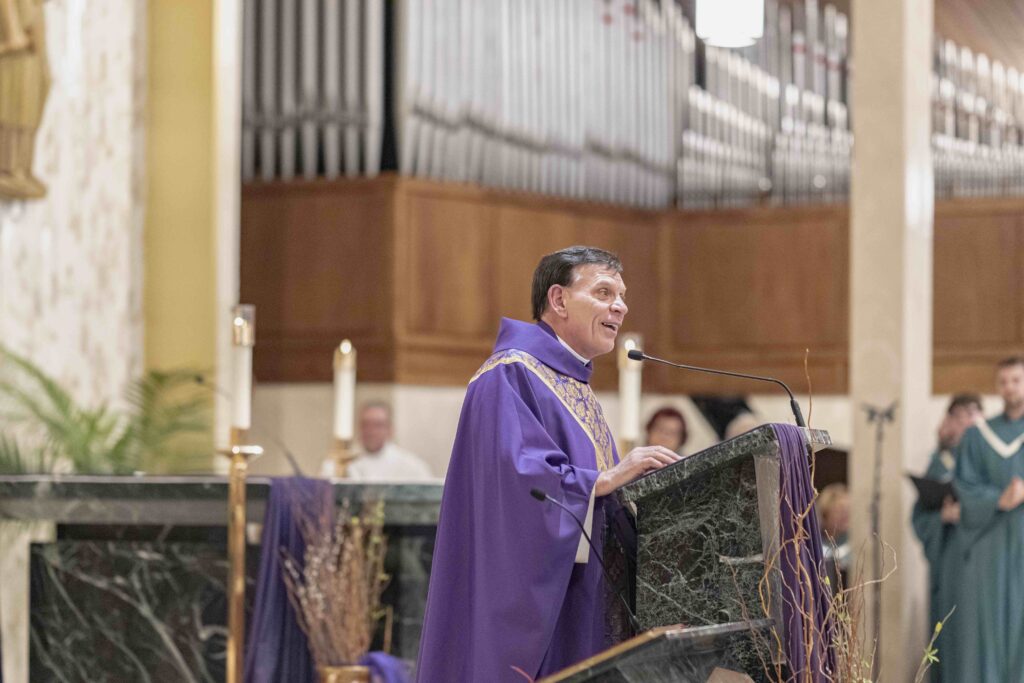 Father Sweirz addresses the congregation at the rededication Mass at St. Patrick Parish. Photo by Brian Keith.