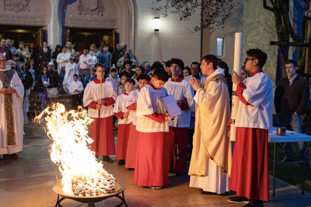 Priest blesses the fire at the Easter Vigil 2024 at St. Dominic's. Photo by Brian Keith.