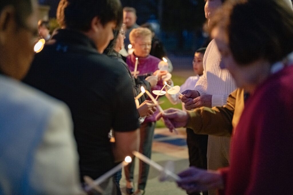 Congregants light their candles at the Easter Vigil 2024 at St. Dominic's. Photo by Brian Keith.