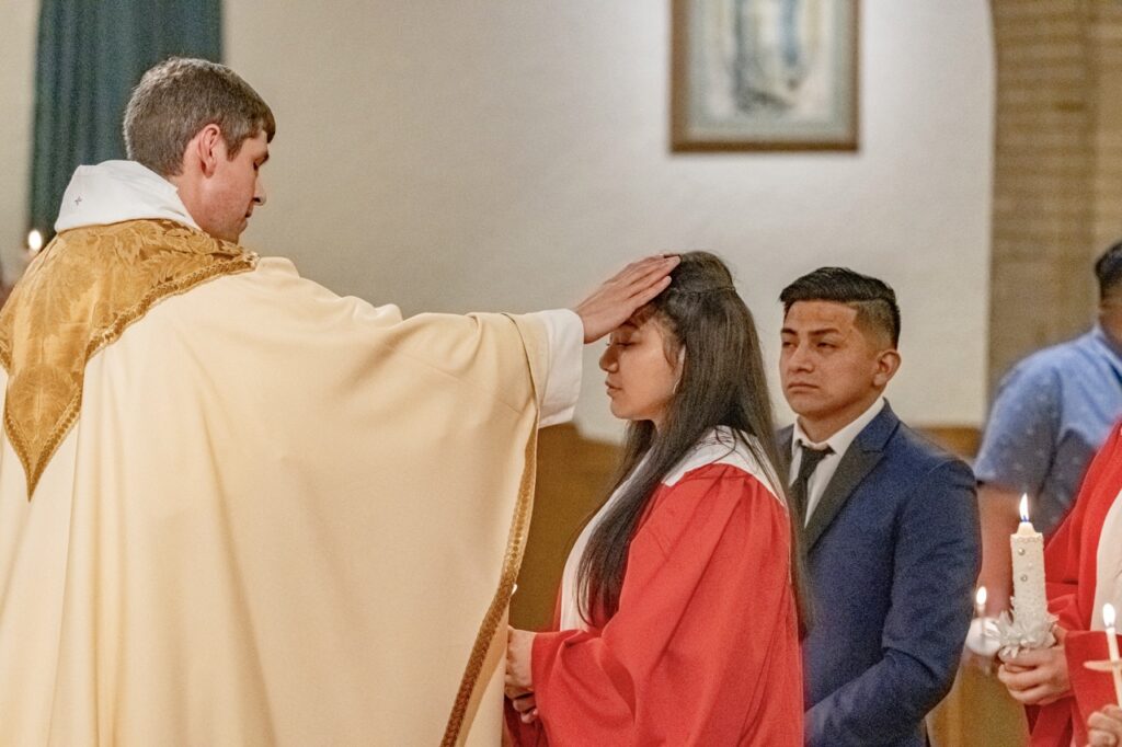 Confirmand is welcomed into the church at the Easter Vigil 2024 at St. Dominic's. Photo by Brian Keith.