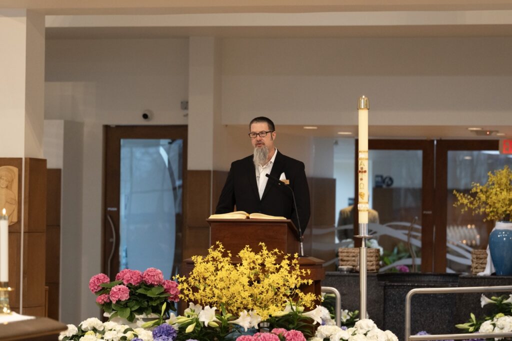 Lector stands at the ambo on Easter Sunday at Blessed Sacrament Parish in Warren. Photo by Brian Keith.