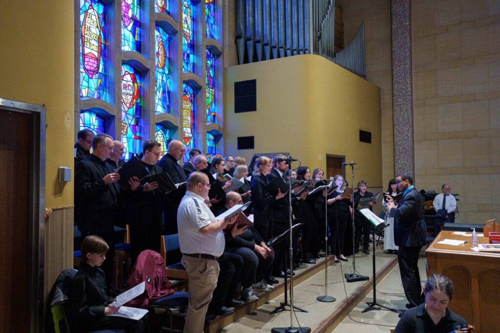 Ralph Holtzhauser directs the choir. Photo by Jimmy Joe Savage. Chrism Mass 2024.