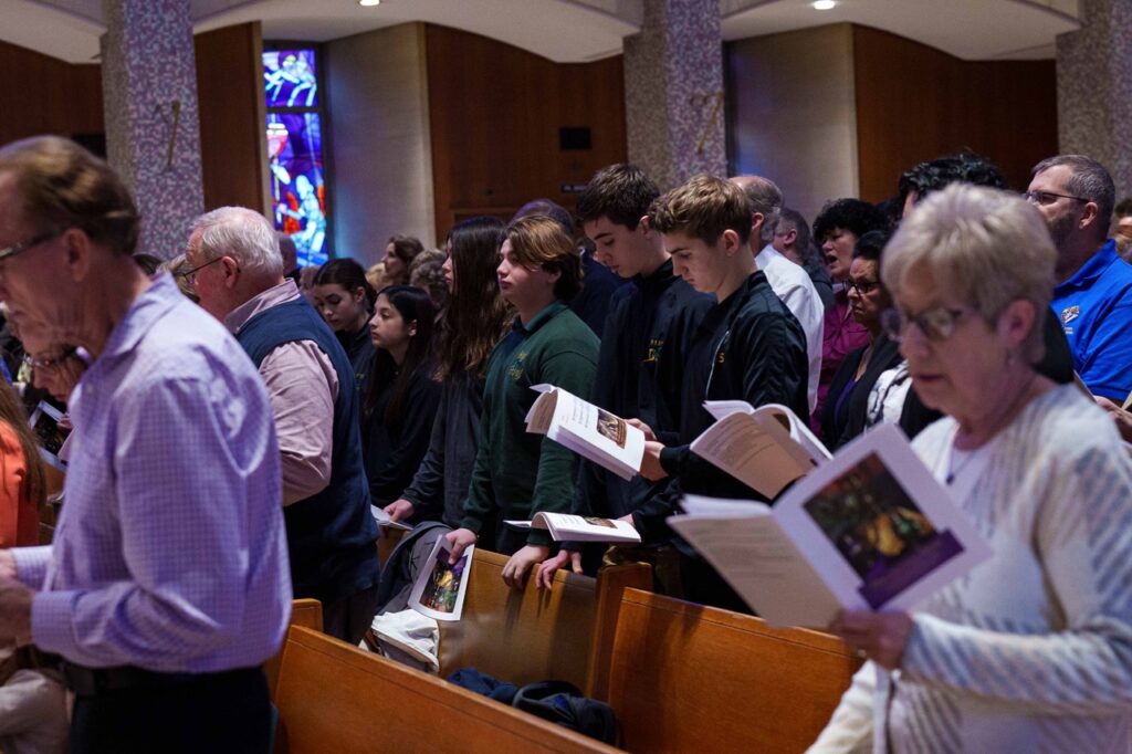 High School students stand during the Mass. Photo by Jimmy Joe Savage. Chrism Mass 2024.