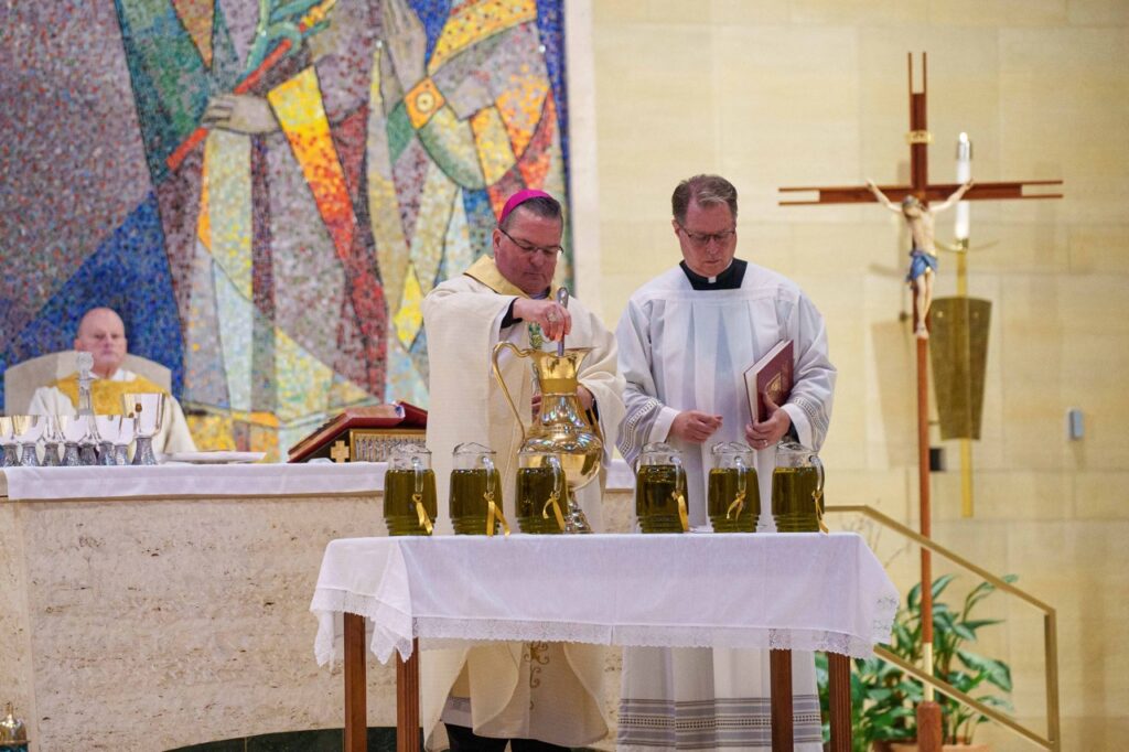 Bishop stirs the holy chrism. Photo by Jimmy Joe Savage. Chrism Mass 2024.