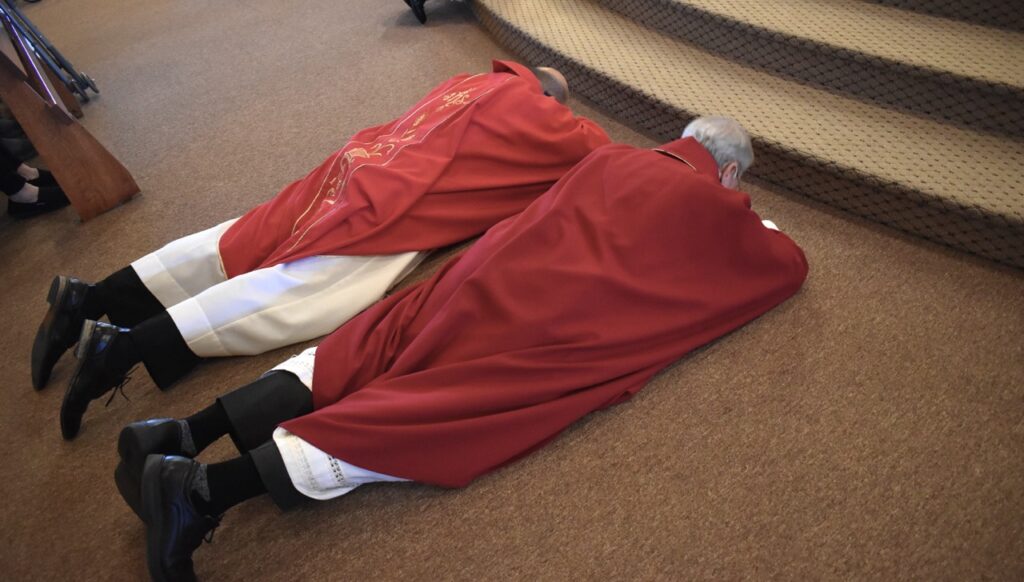 Priest and deacon lay prostrate on the floor during the Good Friday Liturgy 2024 at Our Lady of Peace Parish in Ashtabula. Photo by Marilou McClimans.