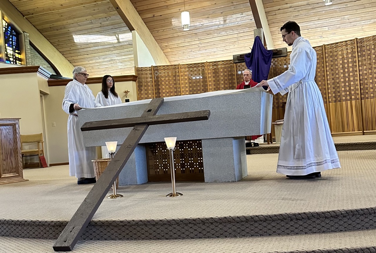 Servers strip the altar after the Good Friday Liturgy 2024 at Our Lady of Peace Parish in Ashtabula. Photo by Marilou McClimans.