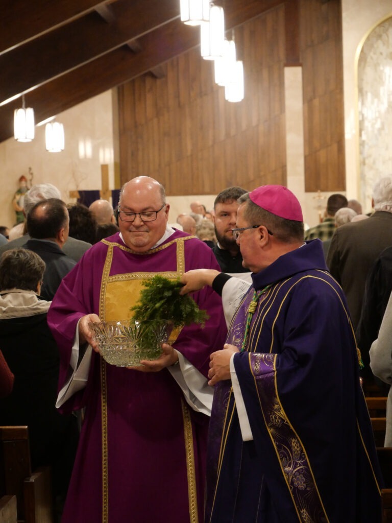 Bishop David Bonnar blesses parishioners with holy water at Mass of Blessing for the re-opening of St. Patrick Parish in Hubbard, Ohio on March 17, 2024. Photo by Michael Houy.