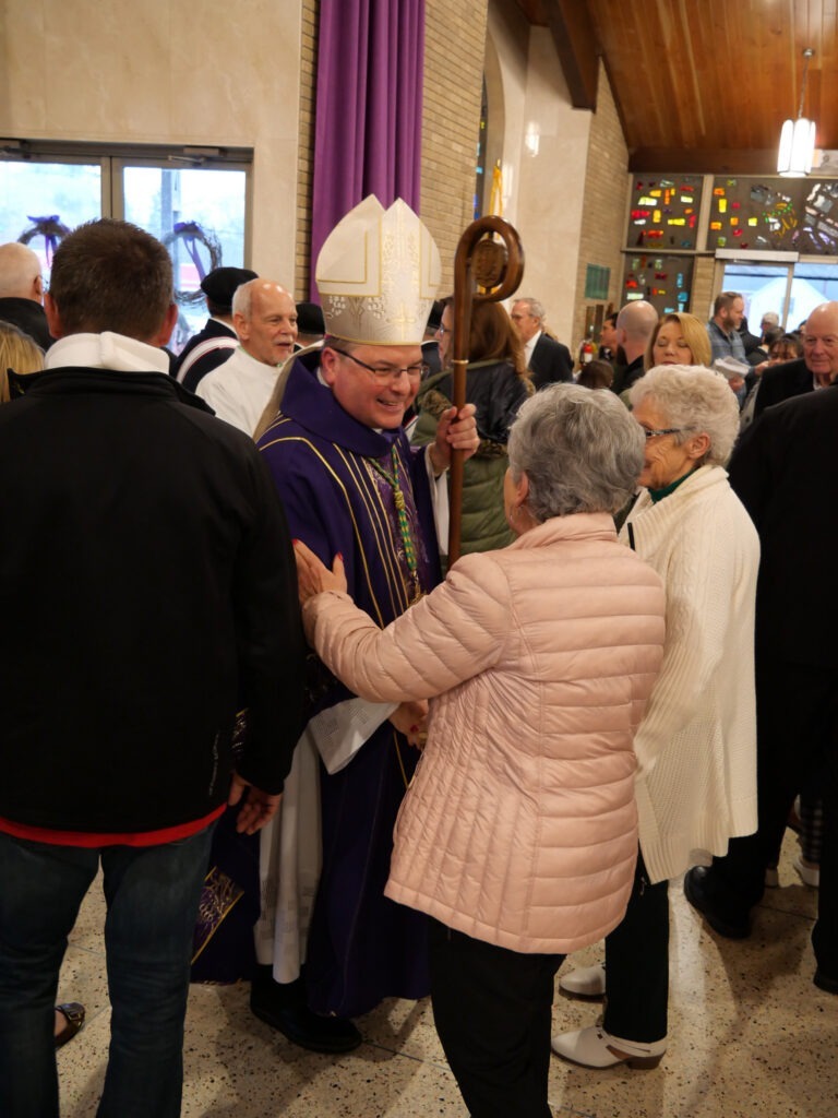 Bishop Bonnar greets parishioners after Mass of Blessing