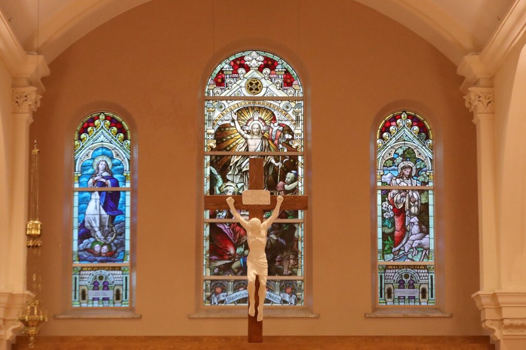 Image of the crucifix, framed by three beautiful stained glass windows at St. Paul Parish in North Canton. Photo by Ed Hall, Jr.