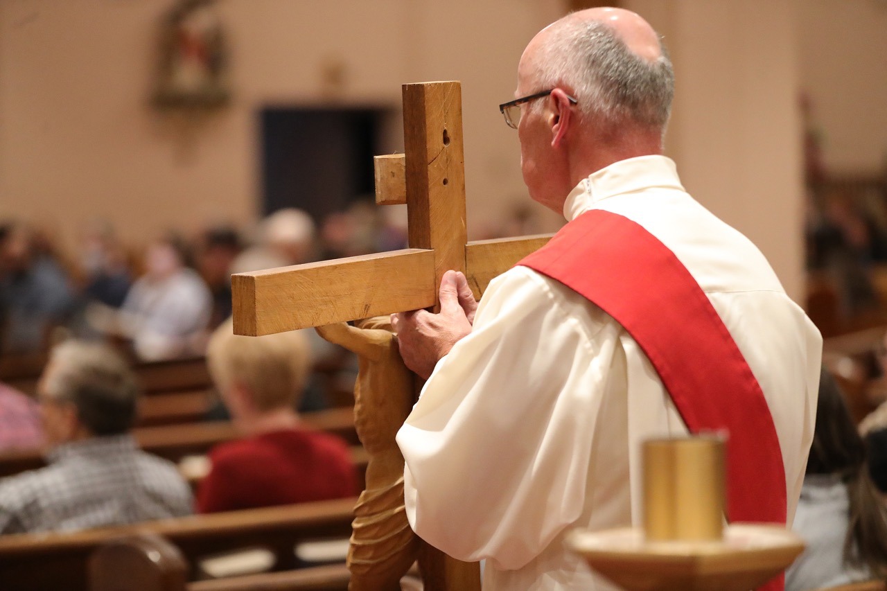 Priest holds the cross for veneration at St. Paul Parish in North Canton on Good Friday 2024. Photo by Ed Hall, Jr.