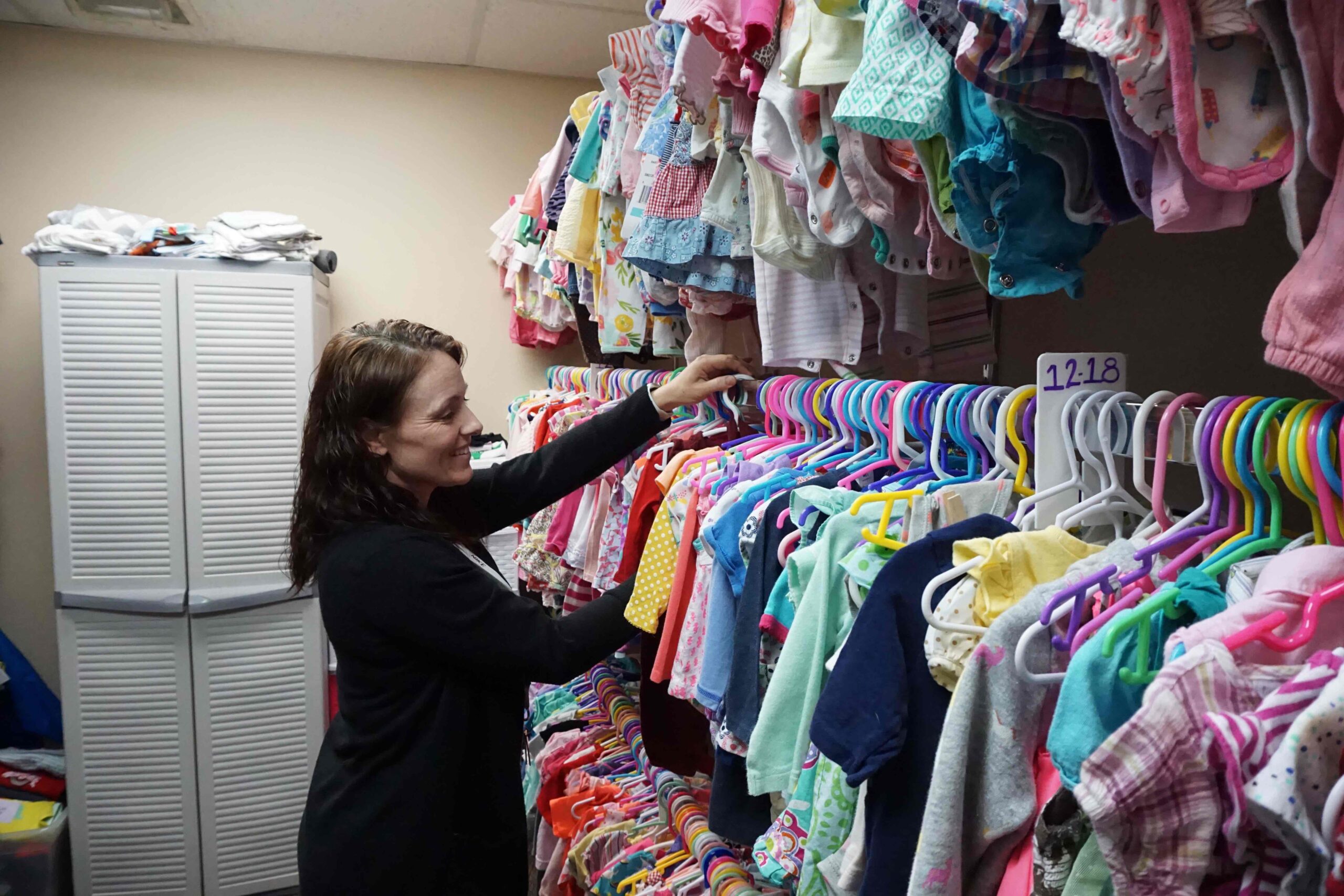 Woman peruses baby boutique at Catholic Charities. Photo by Colln Vogt