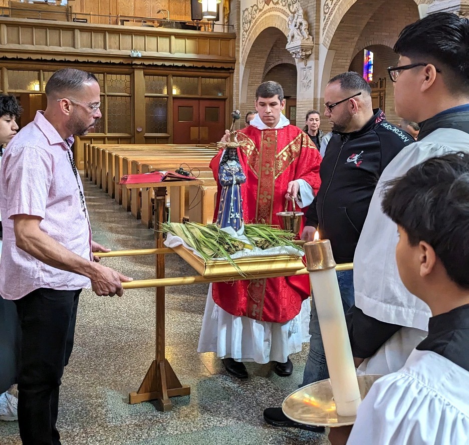 Priest blesses palms during Palm Sunday Mass at St. Dominic Parish in Youngstown.