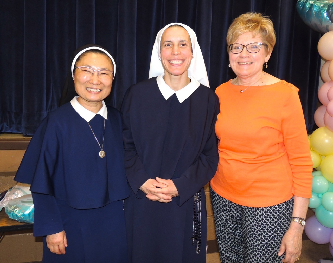 Sisters pose in a photo with lay person from Blessed Sacrament.