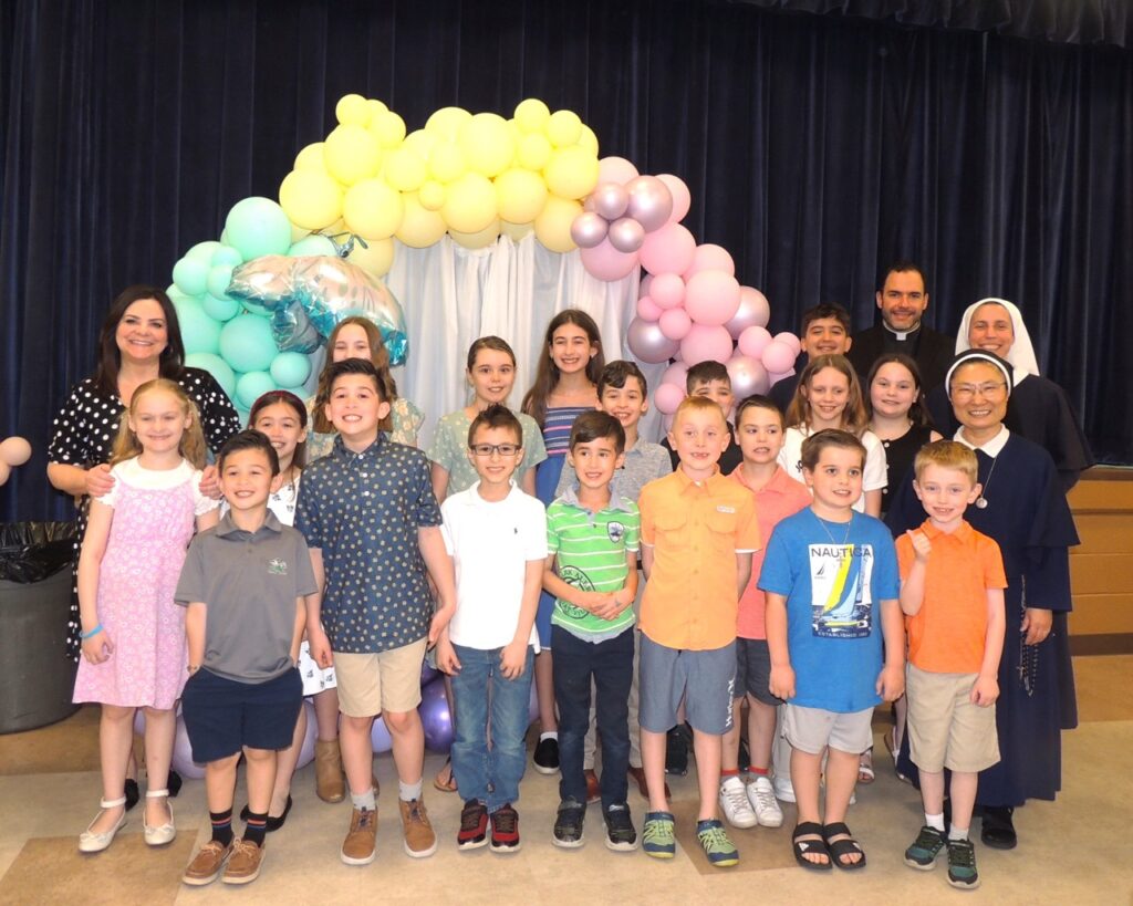 Group stands in front of a balloon display.