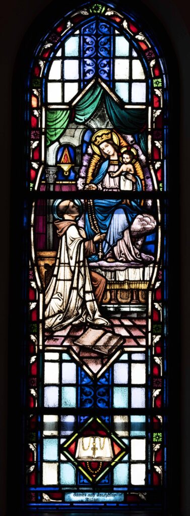 Mary gifts the rosary to Saint Dominic in this Stained glass window. Located at Immaculate Conception Parish in Ravenna. Photo by Brian Keith.