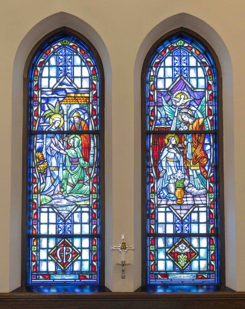Two stained glass windows. On the left, Mary visits with Elizabeth. On the right, the angel Gabriel shines light on Mary. Located at Immaculate Conception Parish in Ravenna. Photo by Brian Keith.