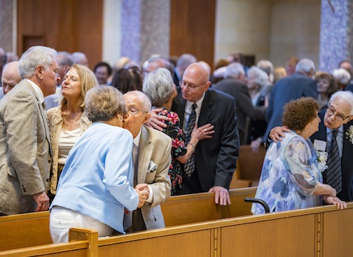 Image of couples "kissing their brides" at the wedding anniversary Mass