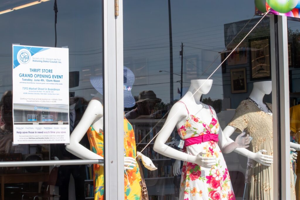 Dresses through a St. Vincent de Paul store window. Photo by Courtney Poullas