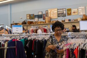 Woman peruses tops in a St. Vincent de paul Thrift store. Photo by Courtney poullas.