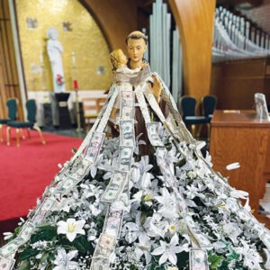 Image of St. Anthony Statue pinned with dollar bills