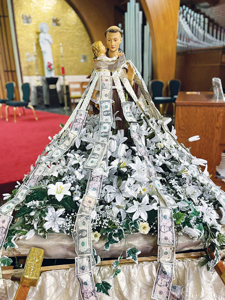 Image of St. Anthony Statue pinned with dollar bills