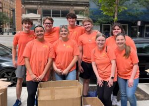 Nine young adults pose for a photo during a service trip