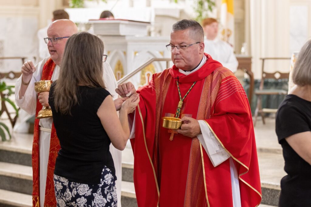 Bishop David J. Bonnar (R) and Very Rev. David Misbrener (L) distribute communion at the Anniversary Mass for Servant of God Rhoda Wise at Saint Peter Church on June 28, 2024. Photo by Bob Rossiter. 