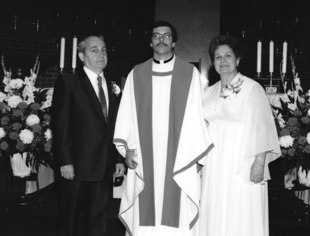 Black and white image of Father popovich with his parents on his ordination day