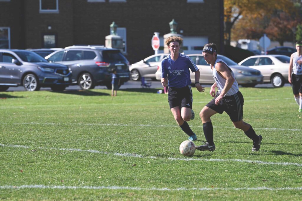 Two seminarians playing soccer