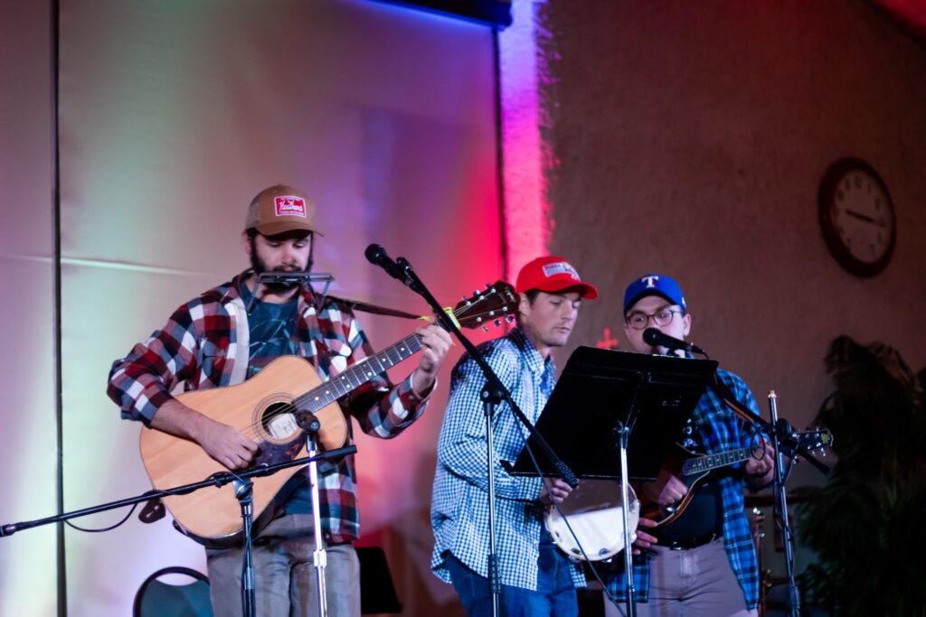 Seminarians performing music with guitars.