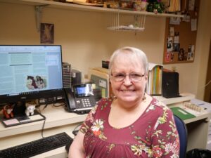 Image of Netta Sweetko, seated by her computer in the Echo offices