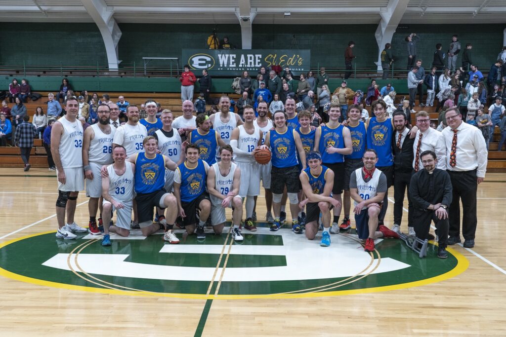 Posed image of the St. Mary Seminary Basketball team, on a basketball court