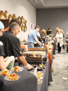 Visitors line up to taste food at the Chefs for Charity event