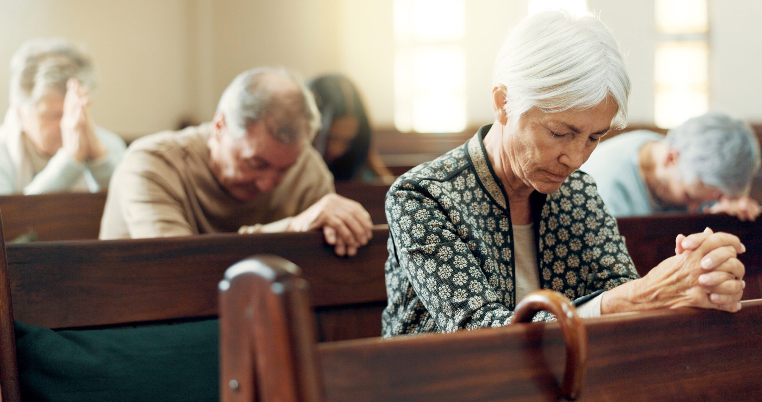 Gospel, prayer or old woman in church for God, holy spirit or catholic religion in cathedral or Christian community. Faith worship, bow or elderly person in chapel or sanctuary to praise Jesus Christ