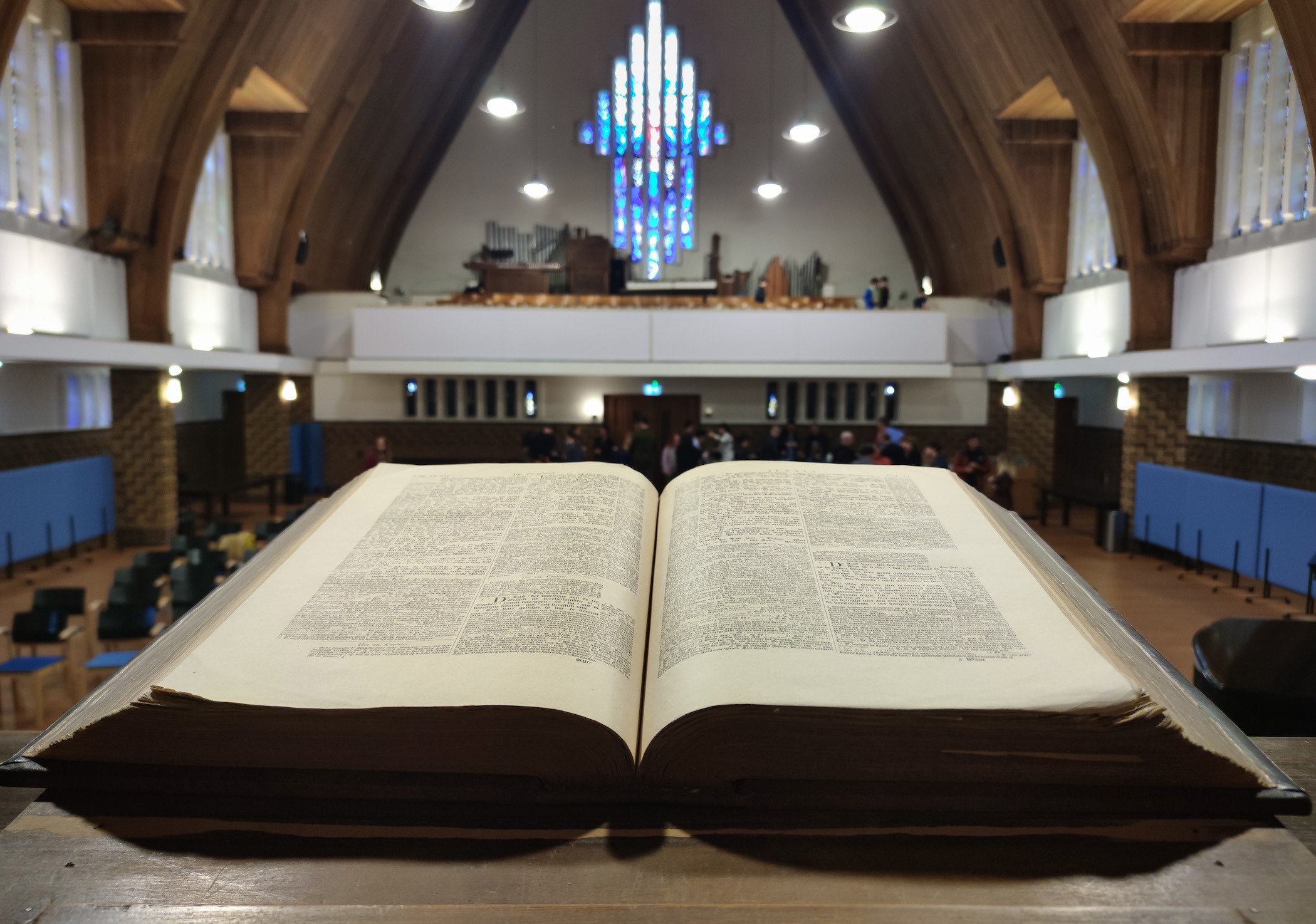 Old Bible with ancient letters on a pulpit in a Protestant church.