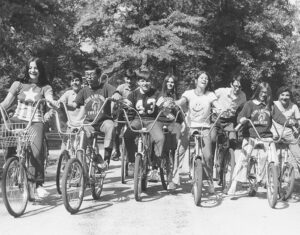 kids ride on bicycles through the park