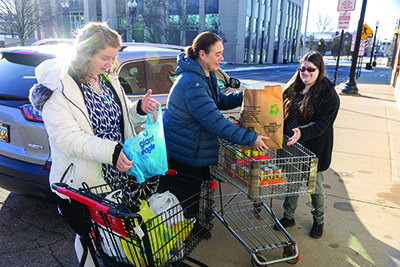 Catholic Charities volunteers load a truck with food