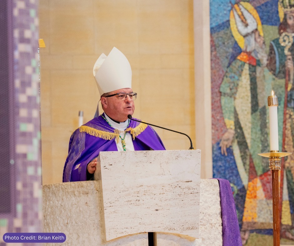 Bishop Bonnar in purple vestments speaks at the lectern