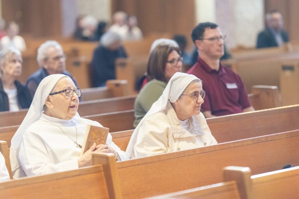 two oblate sisters pray during holy thursday Mass
