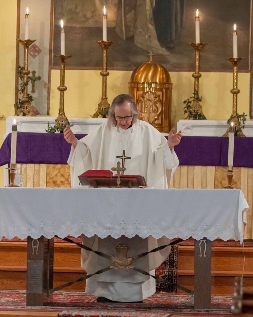 Father prays the Eucharistic Prayers at St. Philip Neri
