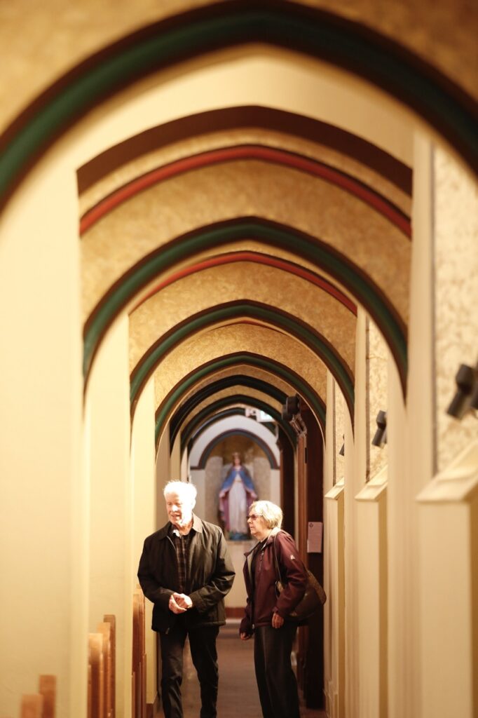 A couple searches for a pew at St. Paul Parish in Salem