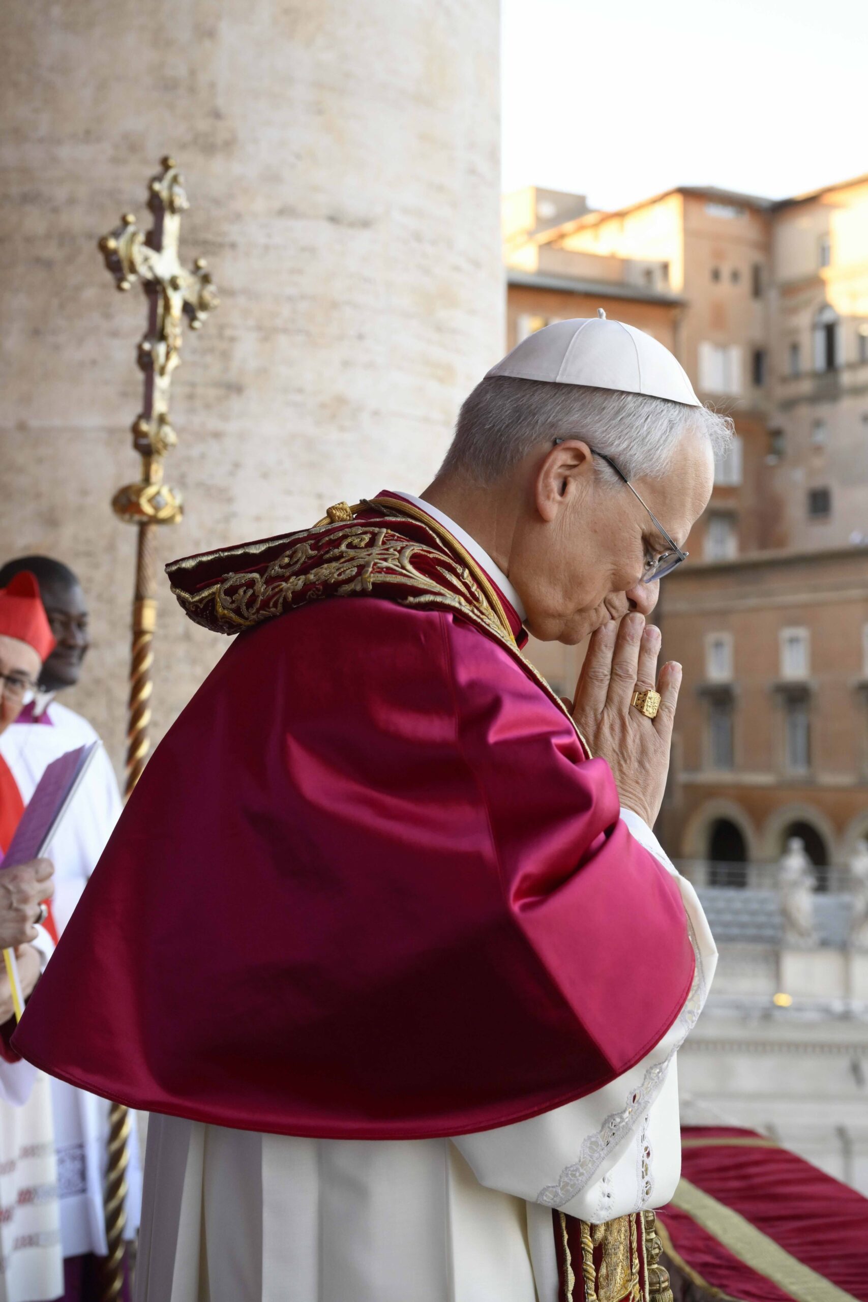 Pope Leo prays while addressing the crowd in St. Peter's Square